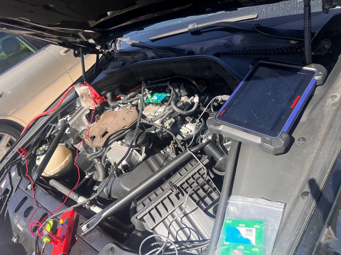 BMW CAS (Car Access System) module removed from vehicle showing electronic unit that controls key authentication and immobilizer